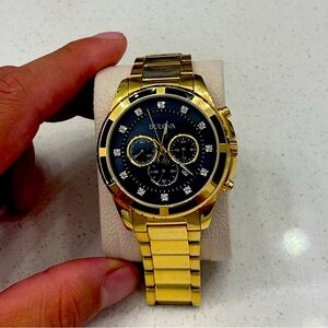 Bulova gold tone watch with diamonds on the face.